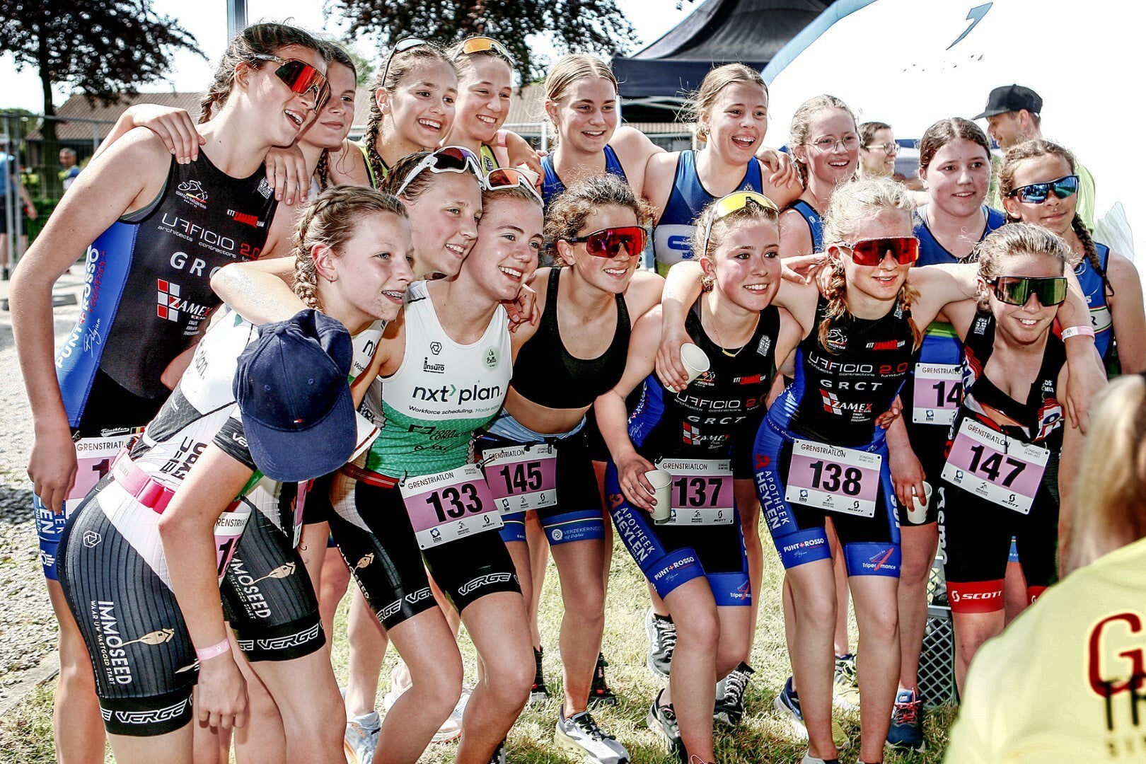 Young female participants smiling after the GrensTriatlon Meetjesland